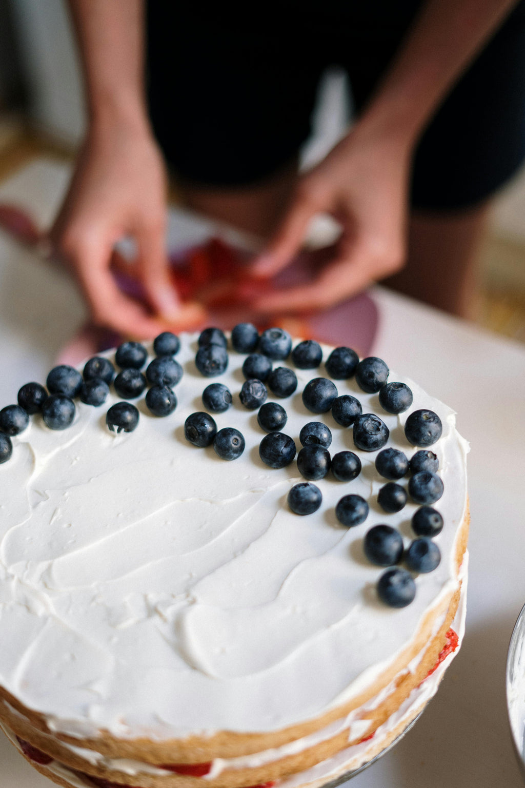 Photo by cottonbro studio: https://www.pexels.com/photo/person-holding-white-cake-with-black-berries-4686834/